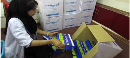 Image of a woman packing ASMO products